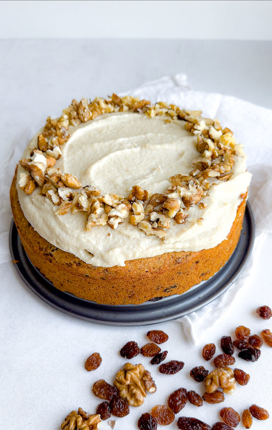 carrot cake that is vegan, gluten free, dairy free, refined sugar free with cashew frosting and walnuts